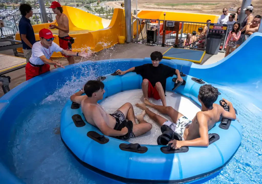 Lifeguard Leonardo Bressan splashes riders as they set out in...