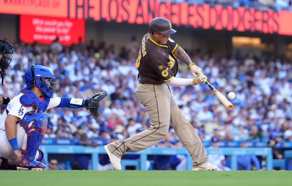 San Diego Padres’ Manny Machado, right, hits a three-run home...