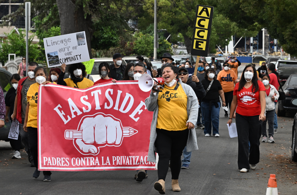 Elizabeth Hernandez uses a bullhorn. Residents and community organizations held...