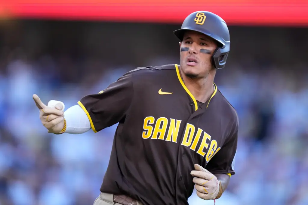 San Diego Padres’ Manny Machado gestures toward his dugout as...