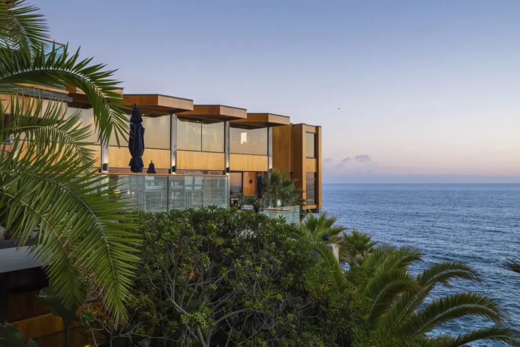 The contemporary estate of wood, glass and concrete cantilevers over...