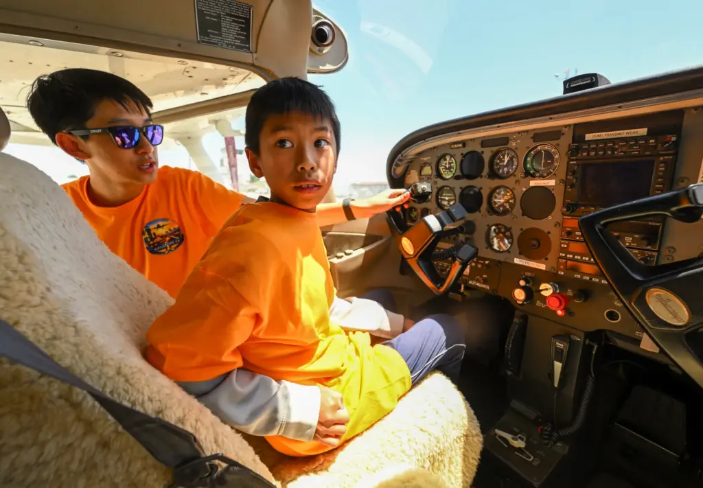 Counselor Baominh Dang moves the yoke and camper Derek Chung...