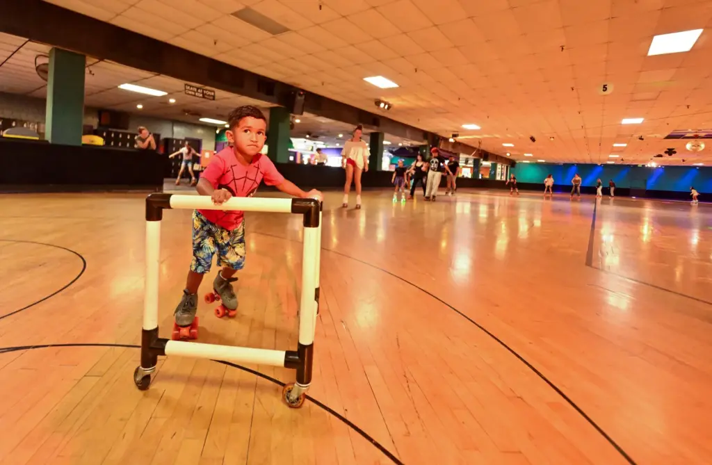 Benjamin Hall, 3, makes his way around the rink at...