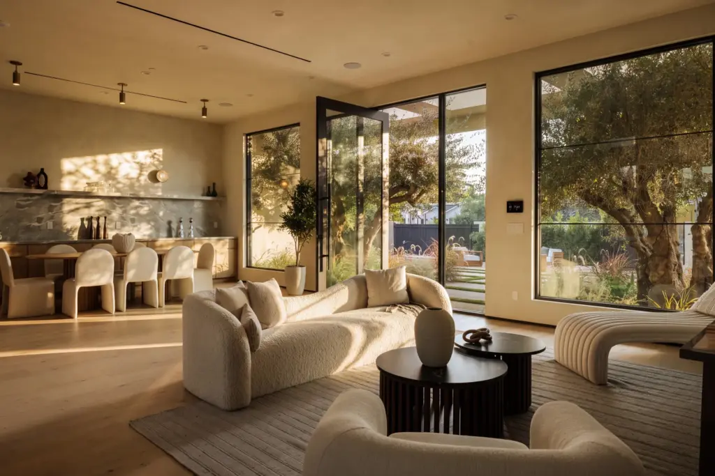 A glass pivot door opens into the main living space....