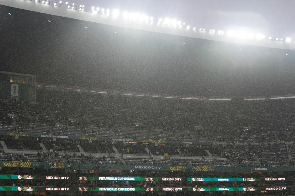 Rain falls as fans wait for the start of the...