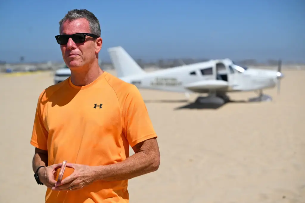 A Piper Cherokee 140 sits on the sand after an...