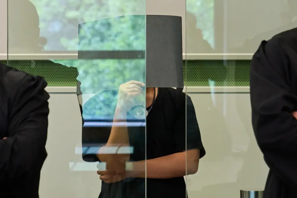 The defendant covering his face in court during a trial