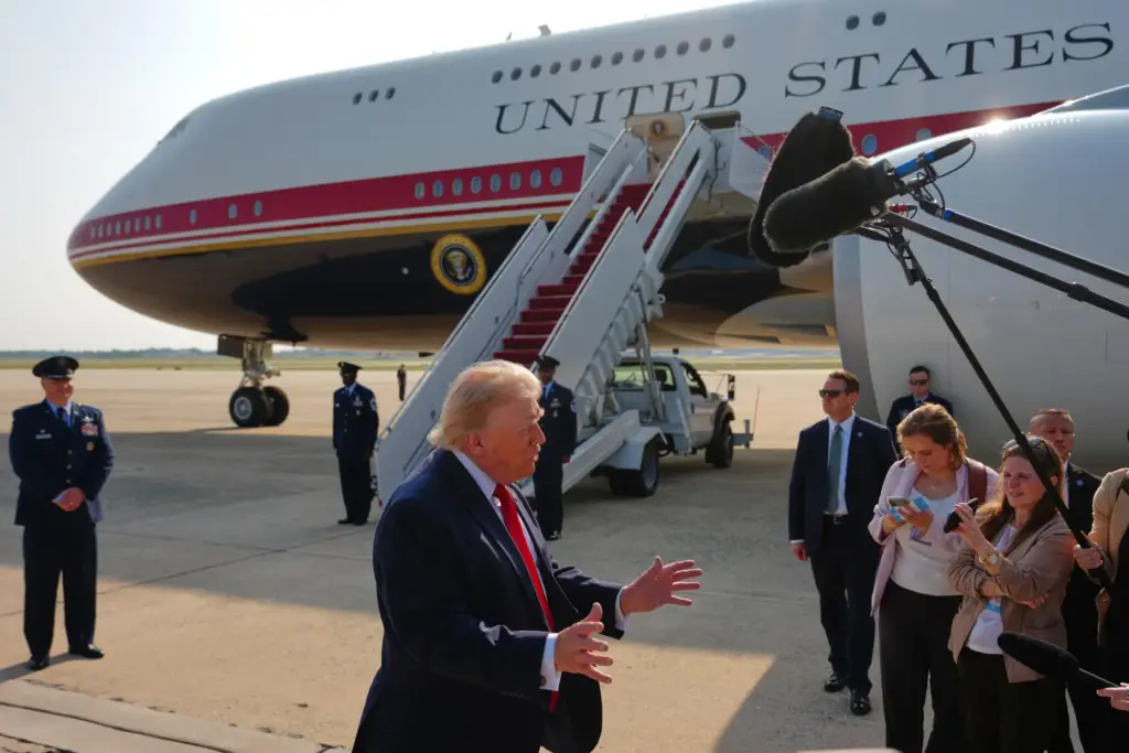 President Donald Trump speaks to reporters before boarding Air Force One.