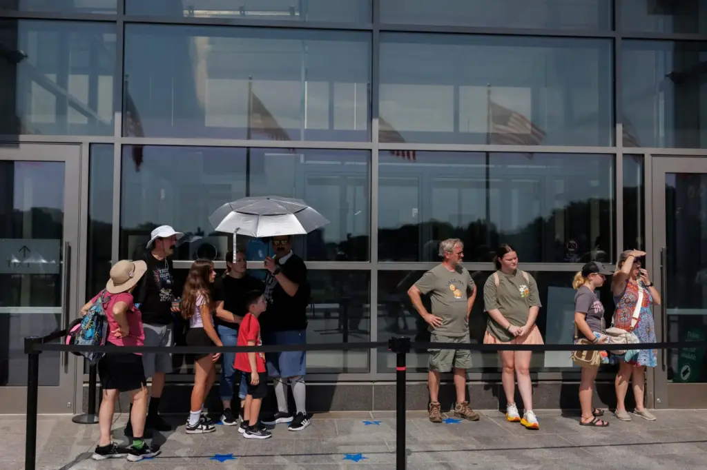 Visitors wait to enter the Washington Monument, Wednesday, July 1,...