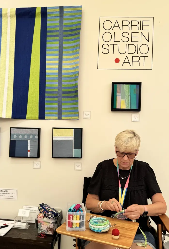 Laguna Woods resident Carrie Olsen works on her fabric art...