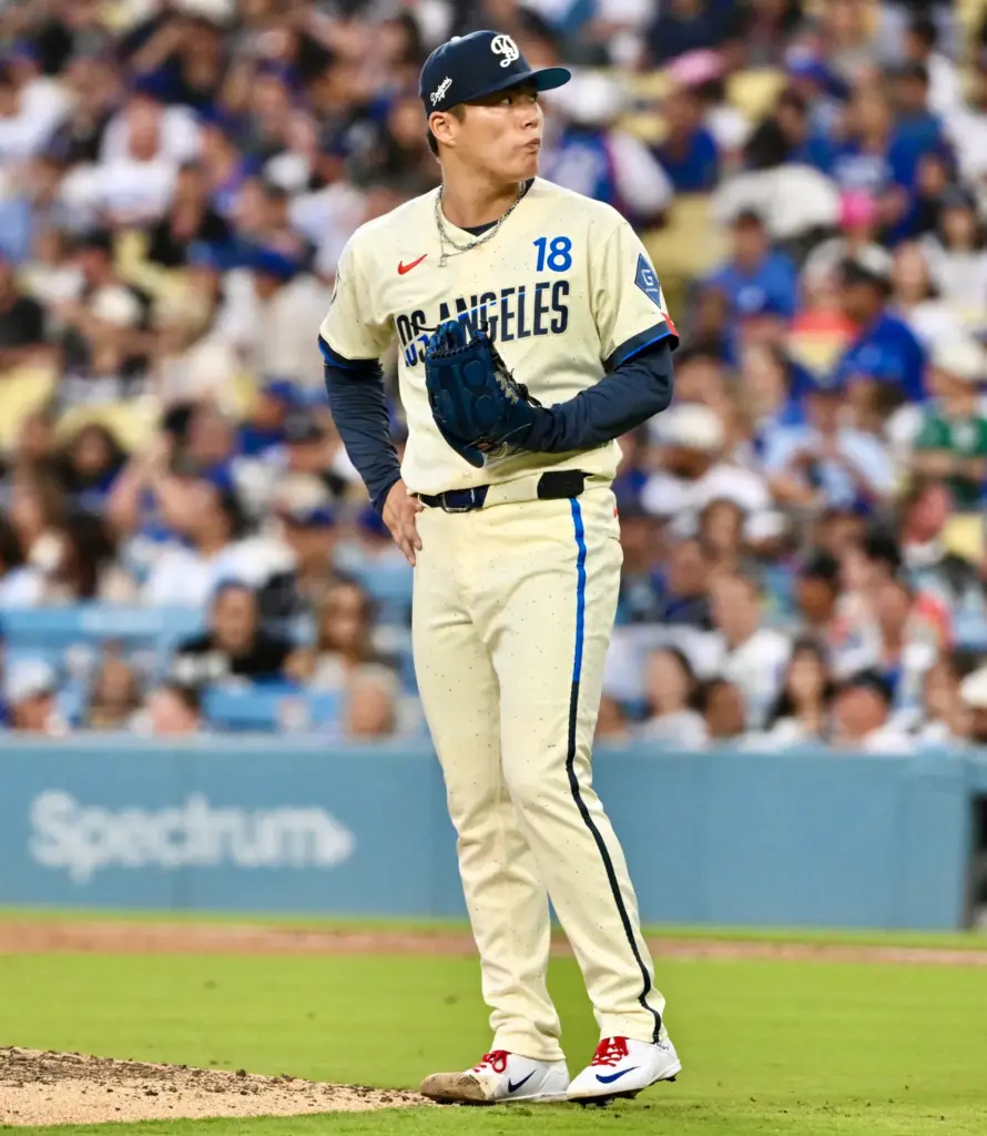 Starting pitcher Yoshinobu Yamamoto of the Dodgers looks on after...
