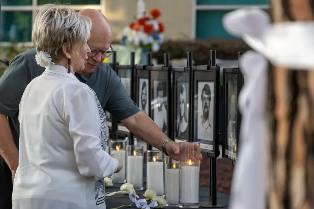 Joe Almazan (left) and Pat Almazan light the candles during...