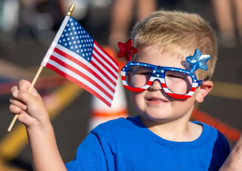 Hayden Gamblin, 4, of Costa Mesa holds out an American...