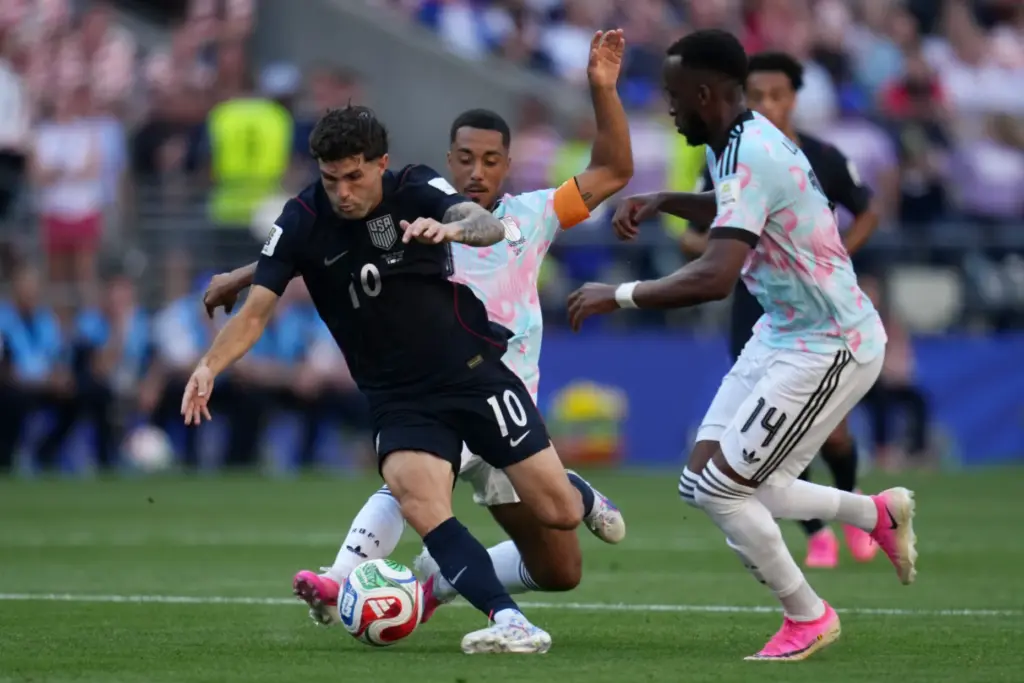United States’ Christian Pulisic, left, tries to get past Belgium’s...