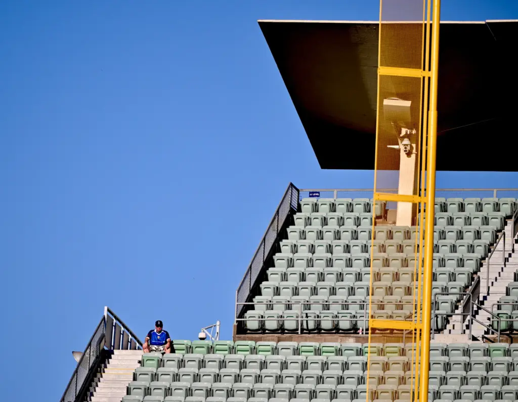 A Dodger fan looks on from the reserve level in...