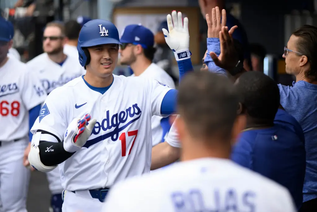 Dodgers’ Shohei Ohtani is greeted in the dugout after hitting...