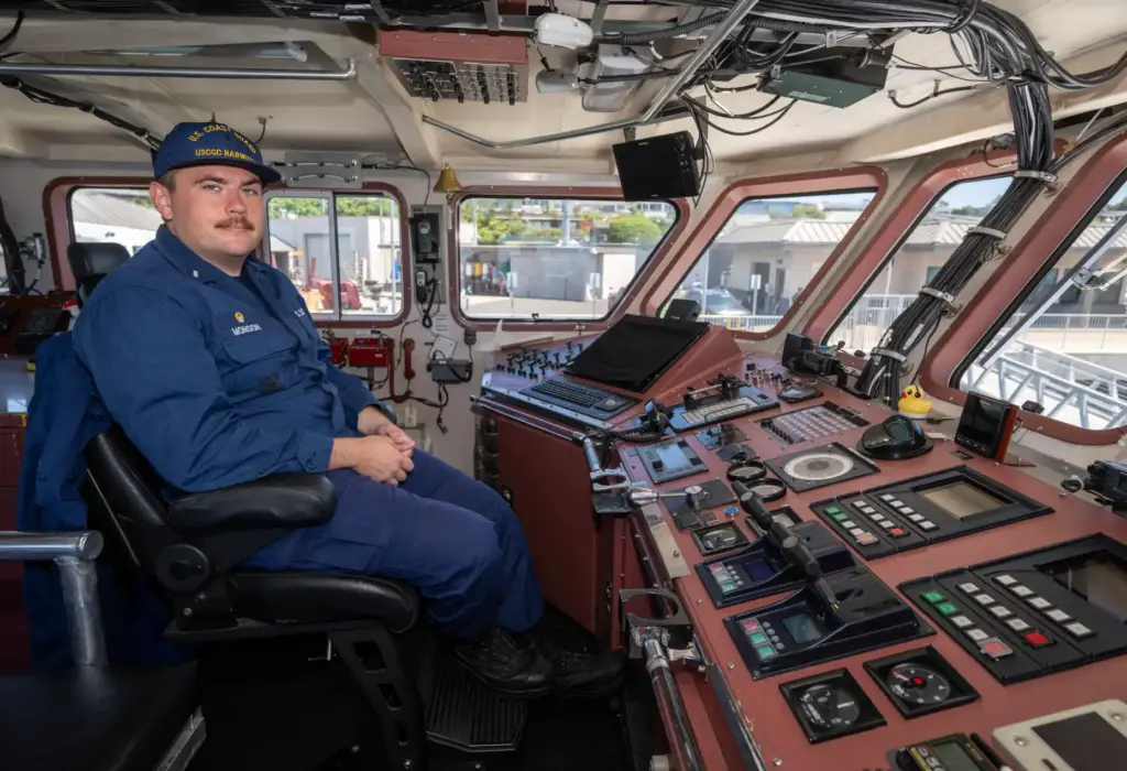 Lt. Jake Monson sits on the bridge of the US...