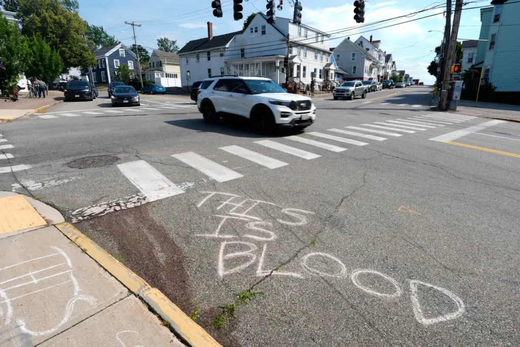 Blood is seen on the pavement near the scene of a shooting involving ICE.