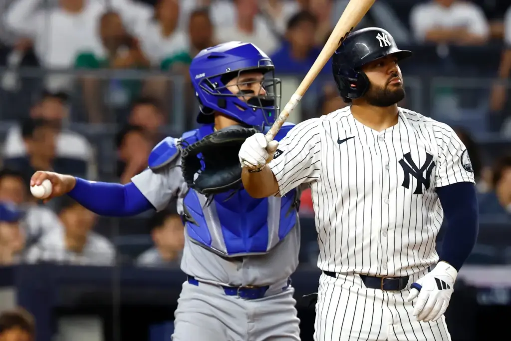 New York Yankees’ Jasson DomÃ­nguez, right, looks on after striking...