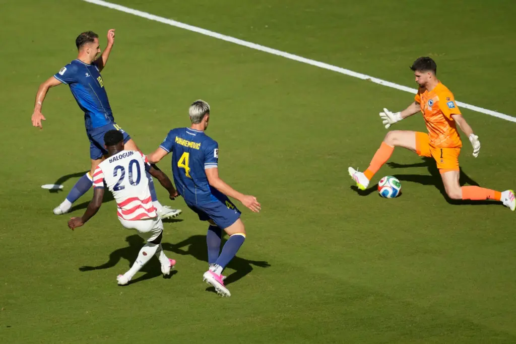 The United States’ Folarin Balogun (20) scores their first goal...