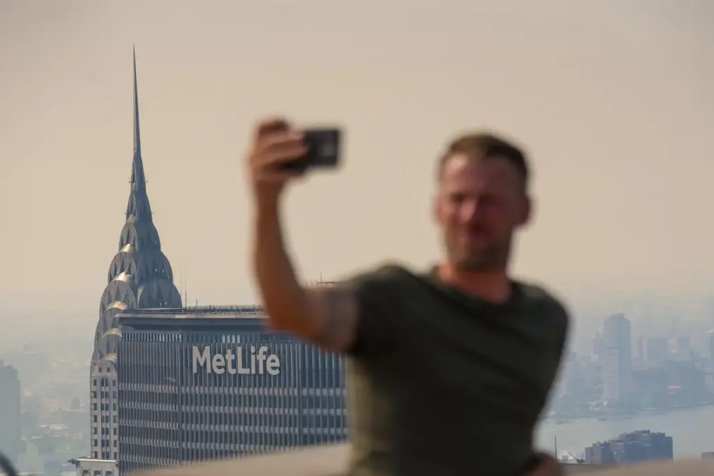 A person takes a selfie from the Top of The...