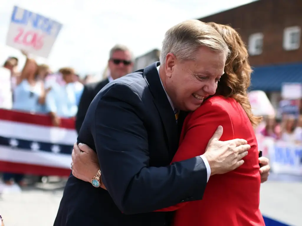 FILE – Sen. Lindsey Graham, R-S.C., left, hugs his sister...