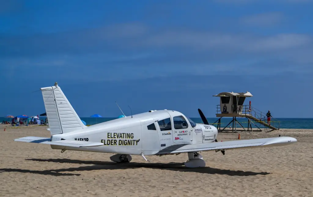 A Piper Cherokee 140 sits on the sand after an...
