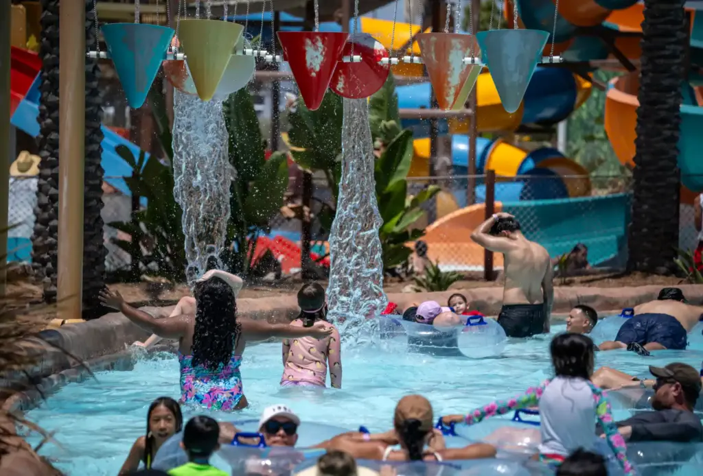 Buckets dump water on Wild Rivers guests as they float...