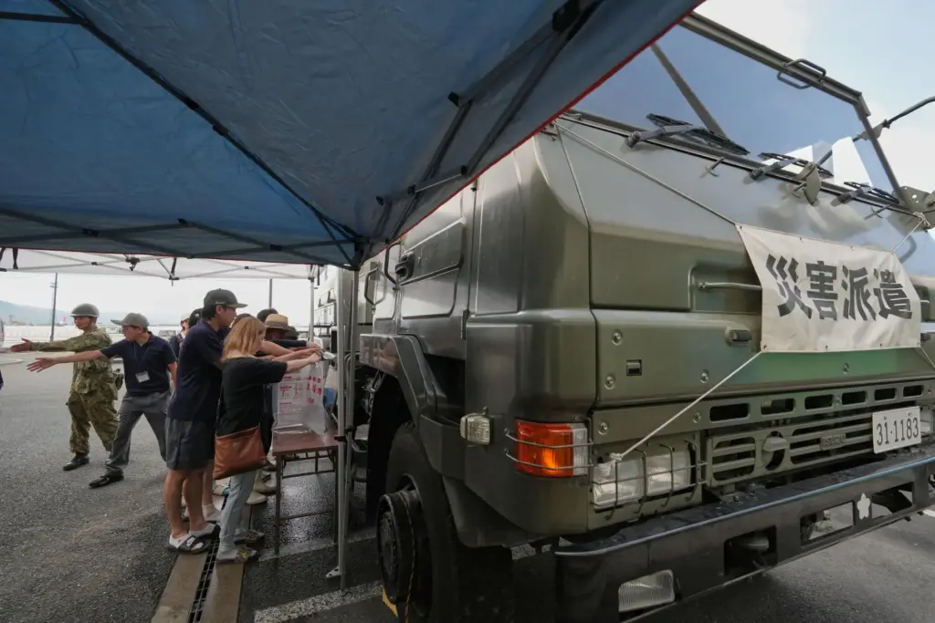 Residents receive a water supply after water service was disrupted following an earthquake.