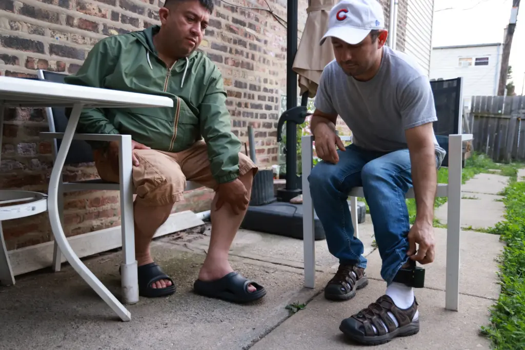 Outside their apartment in Cicero, Alfredo Pacheco, left, and JosÃ©...