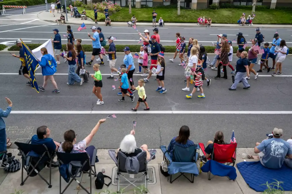 AYSO Region 84 athletes and their families walk together during...