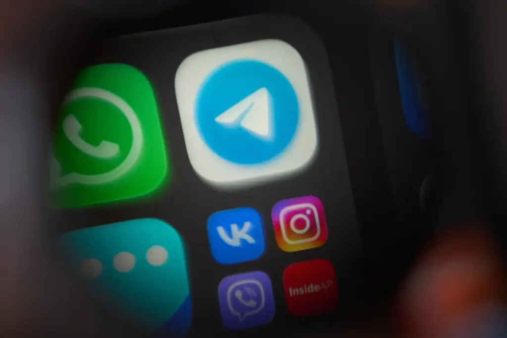 The app Telegram is shown on a smartphone.