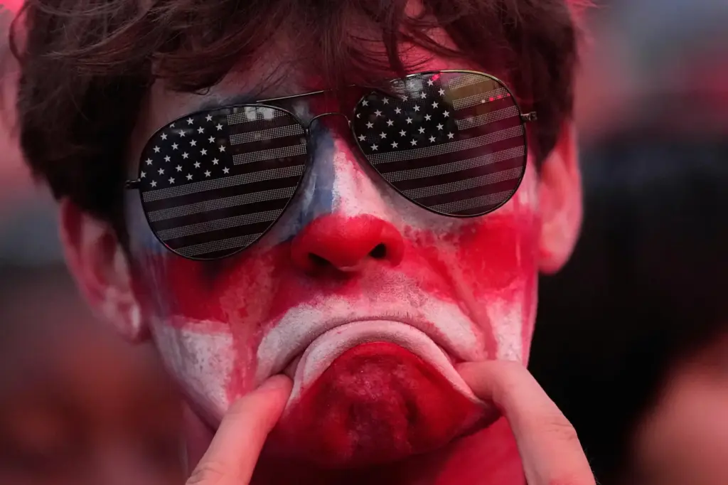 A fan reacts to the United States' loss against Belgium.