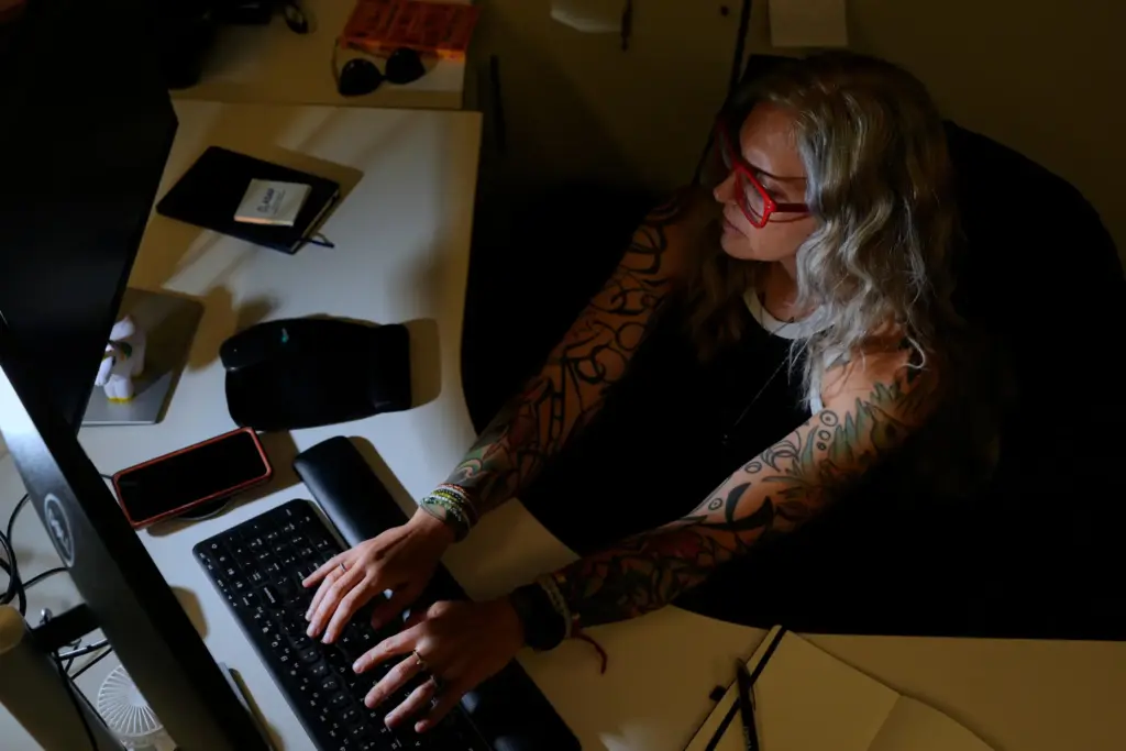 Deanna Danger types an AI prompt into her computer.