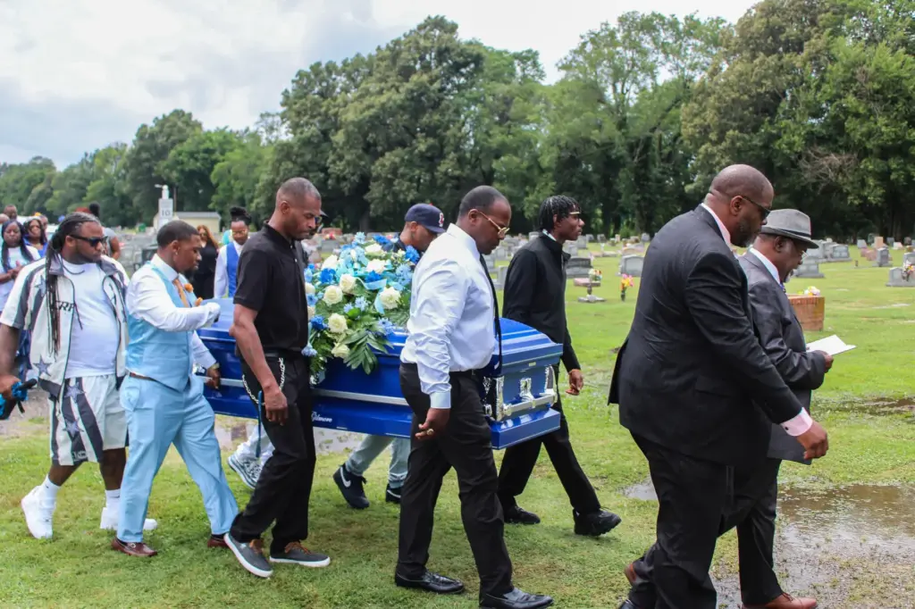 Pallbearers carry Lloyd Gilmore to his grave in Sikeston, Missouri.