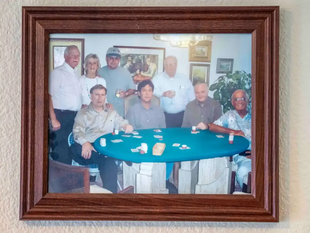 A framed photo showing a group of friends playing poker...