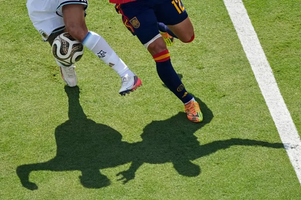 Argentina’s Nico Gonzalez (15) challenges for the ball with Spain’s...