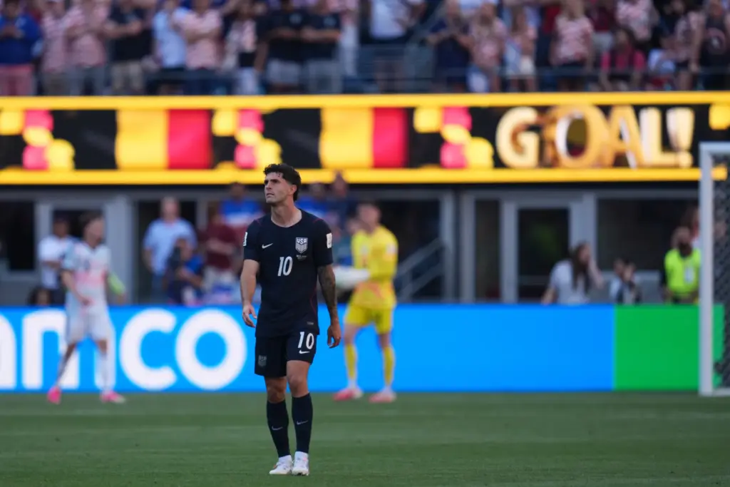 United States’ Christian Pulisic walks the field after Belgium scored...