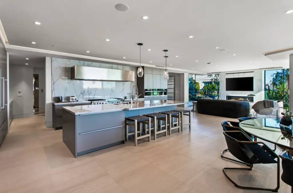 A large center island anchors the modern kitchen, which opens...