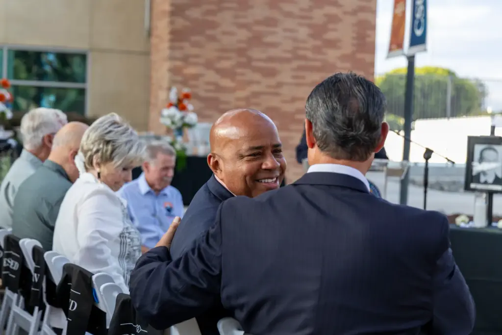 Cal State Fullerton President Ronald S. Rochon smiles at District...