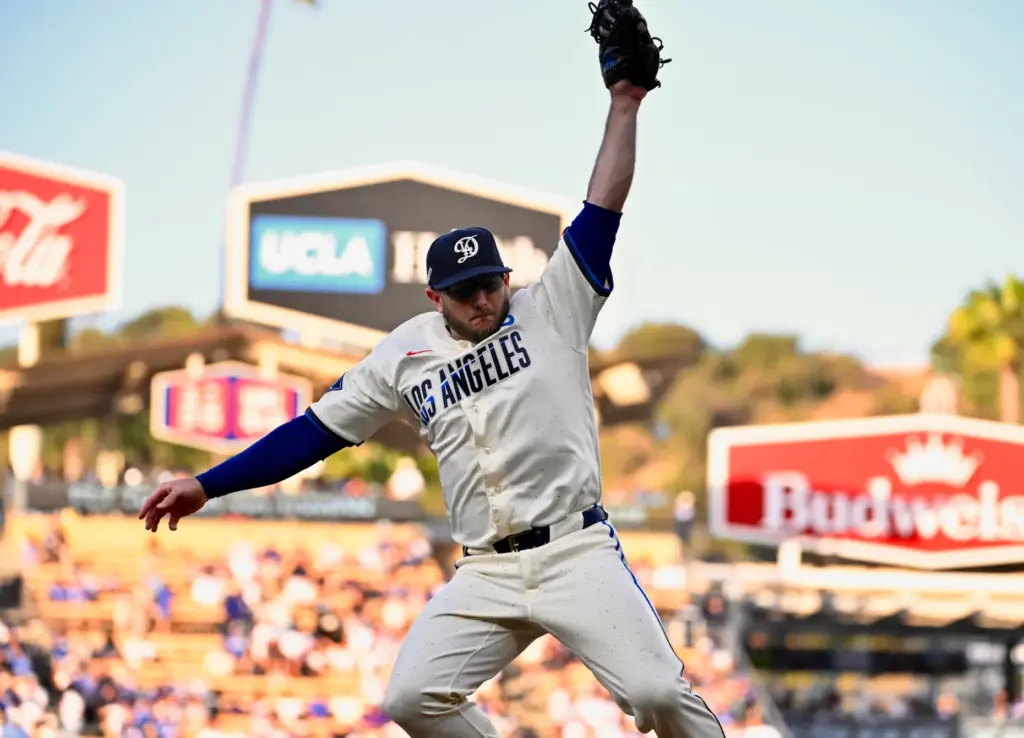 Third baseman Max Muncy of the Dodgers makes a leaping...