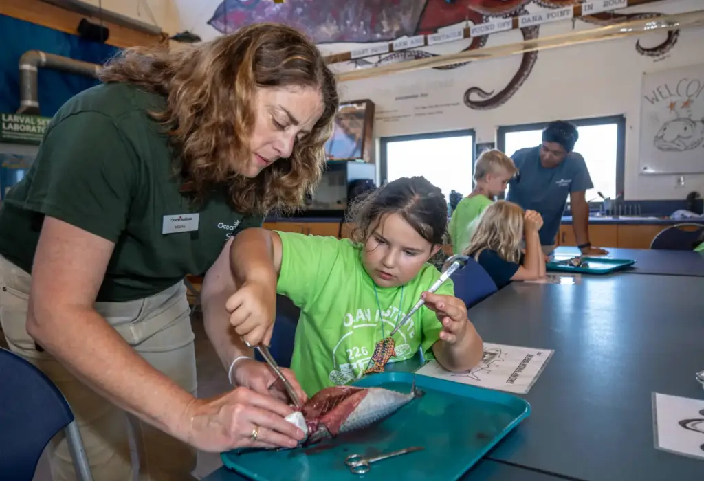 Megan Morrow, left, an Ocean Institute summer camp instructor, helps...