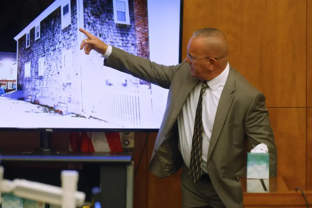 Duxbury fire department Capt. PJ Hussey points to a photograph as he testifies.