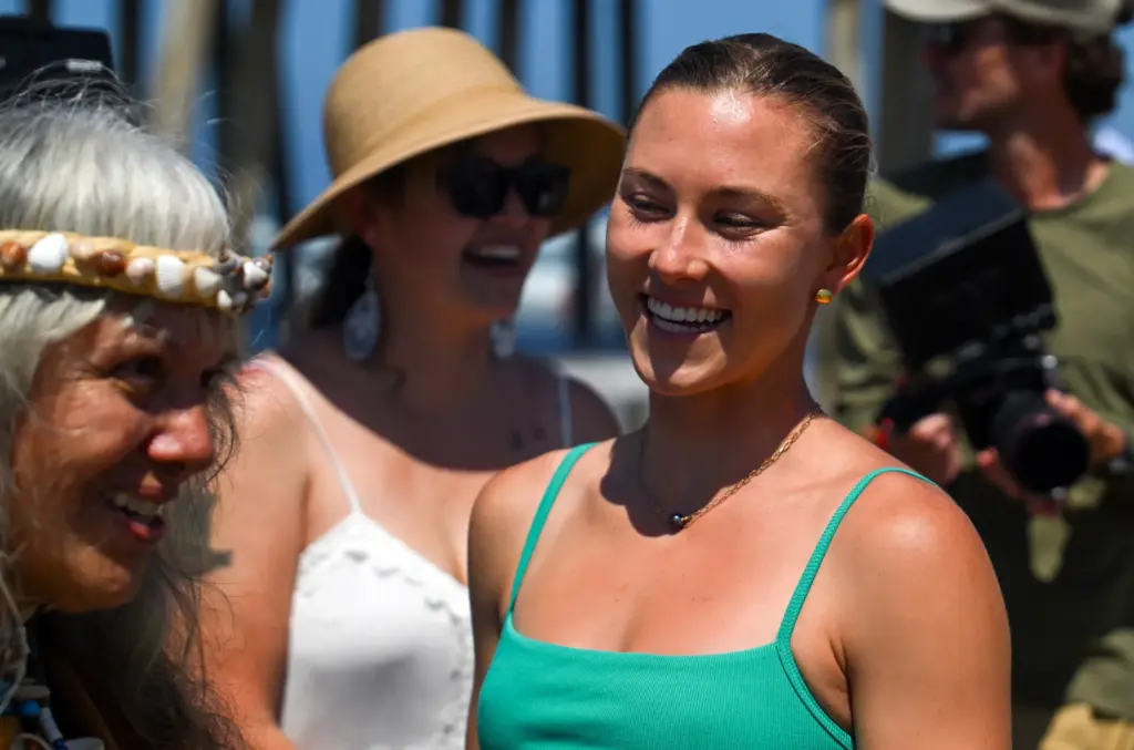 Pro surfer Alyssa Spencer gets a blessing from Tushmaluum Heleckatuum,...