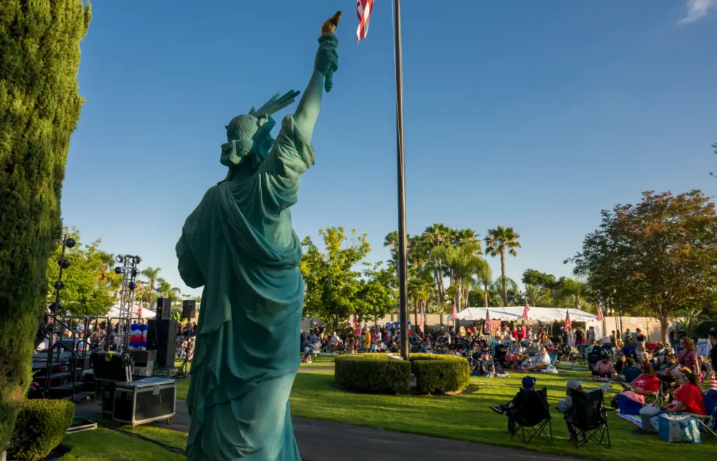 A scale replica of the Statue of Liberty, left, faces...