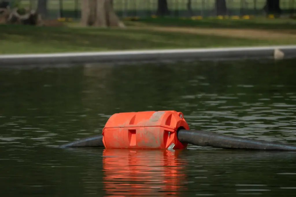 A length of hose supported by a float is pictured...