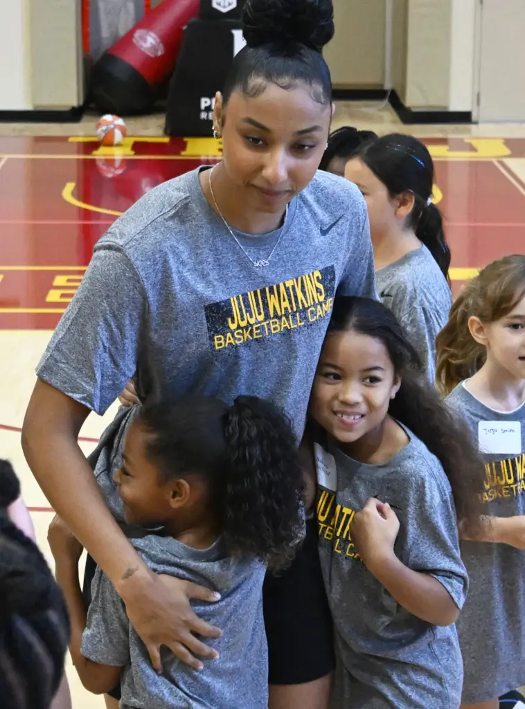 JuJu Watkins gets hugs from campers as she hosts a...