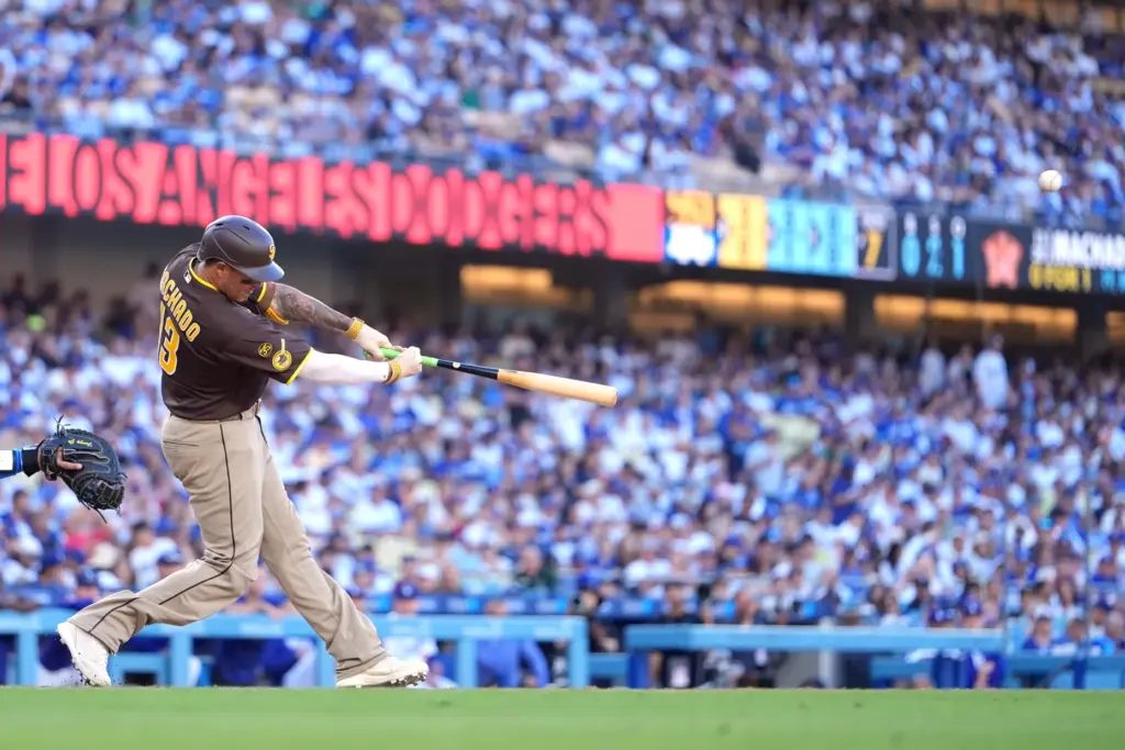 San Diego Padres’ Manny Machado hits a three-run home run...