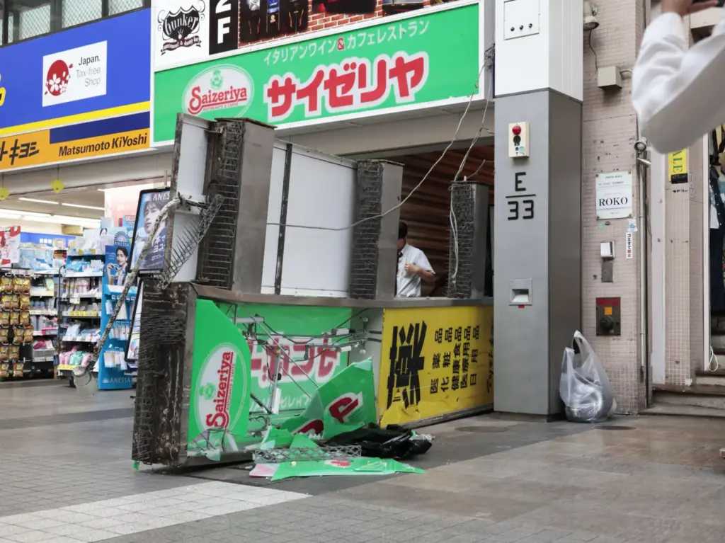 A store sign of a restaurant is seen fallen on the ground after an earthquake.