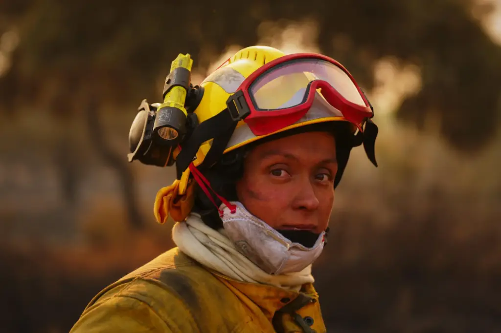 A firefighter pauses while battling a wildfire in San Martín...